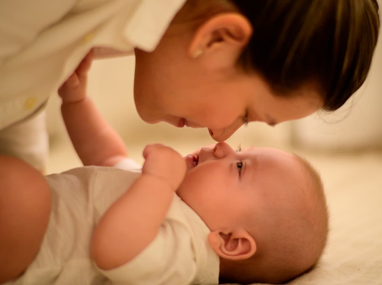 A parent gently caring for their baby